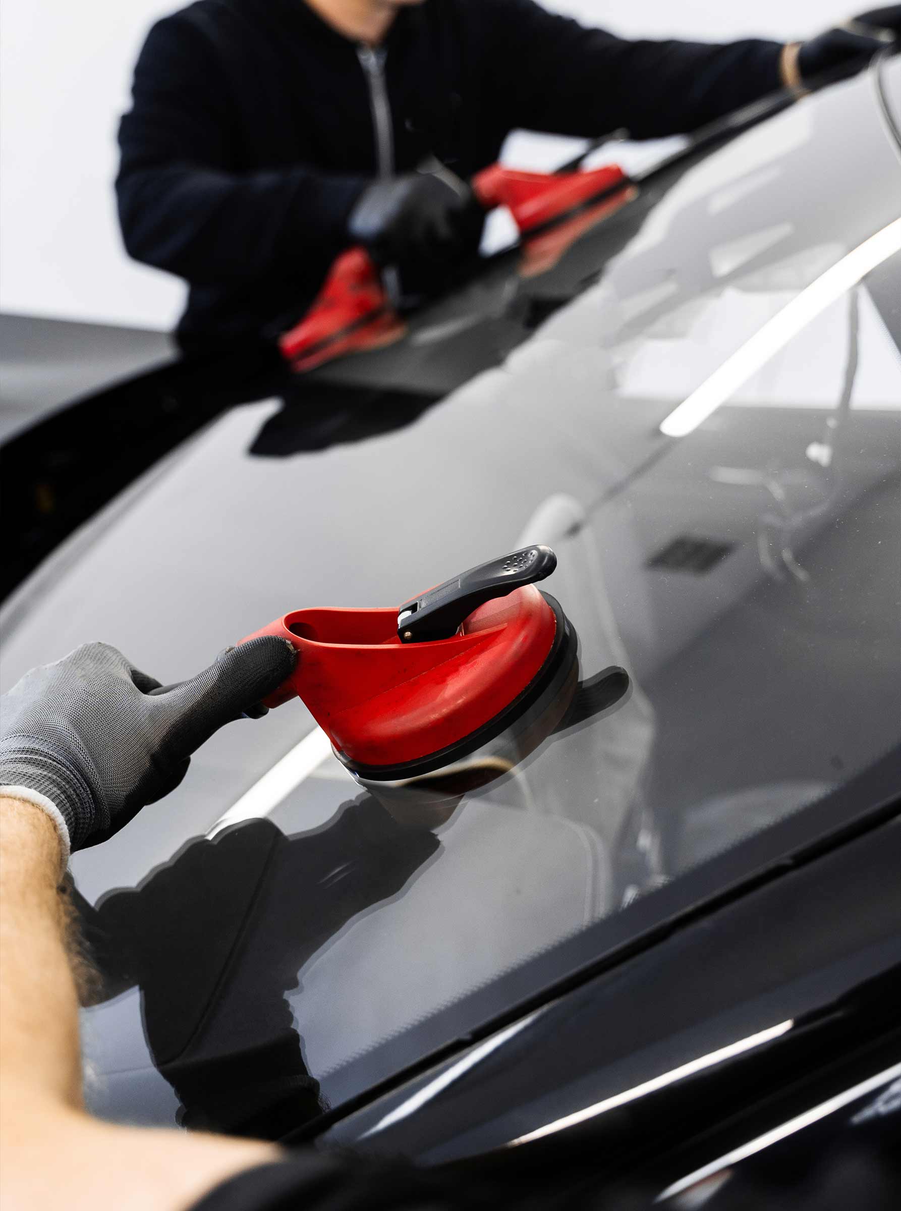collision repair technicians replacing windshield in San Diego body shop